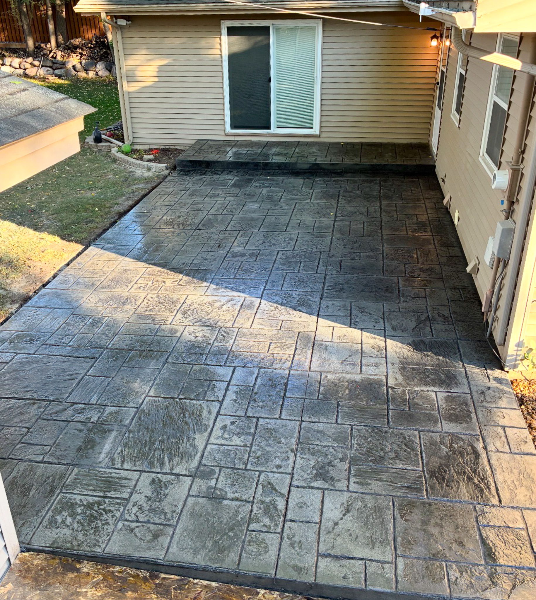 Stamped concrete patio with brick pattern by A&J Custom Concrete in Ramsey, MN